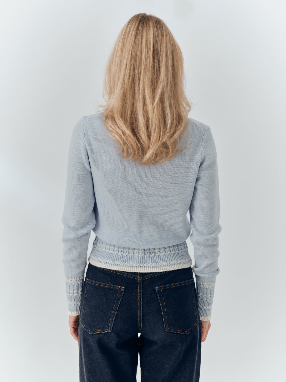 Betsy Jumper in Powder Blue cashmere, worn with dark denim, back.