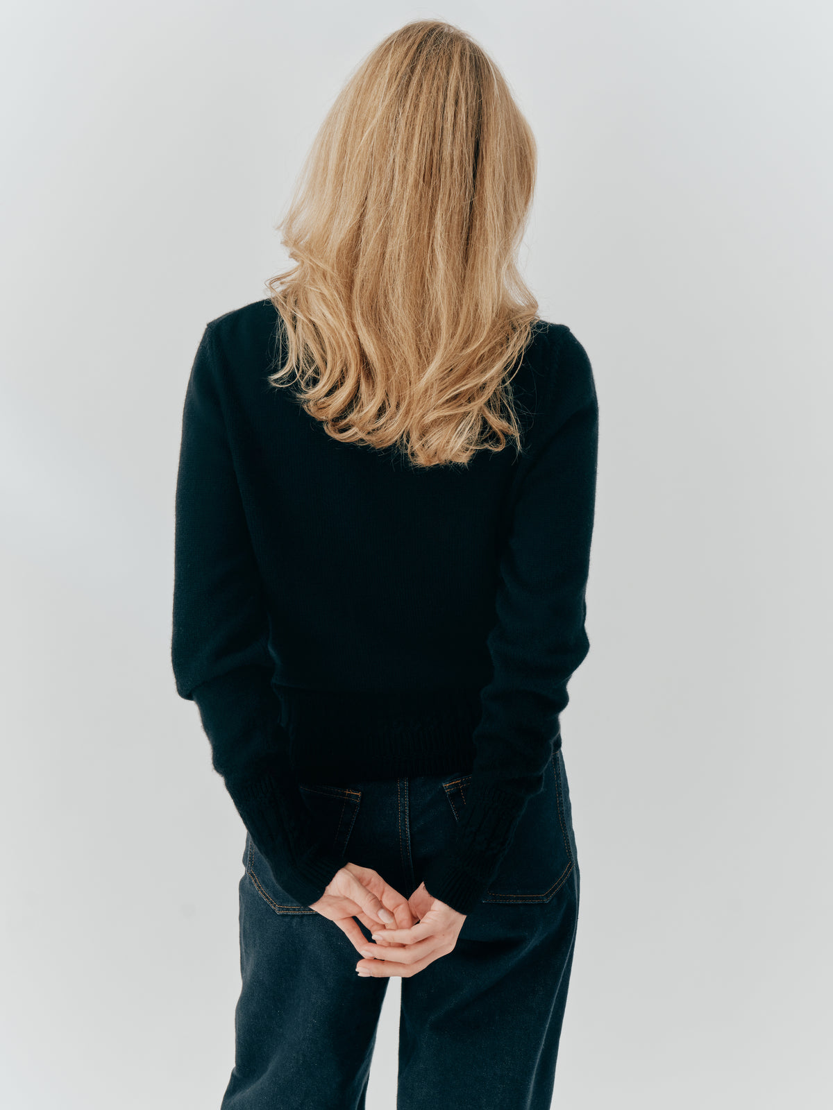 Betsy Jumper in Black cashmere, back view worn with dark denim