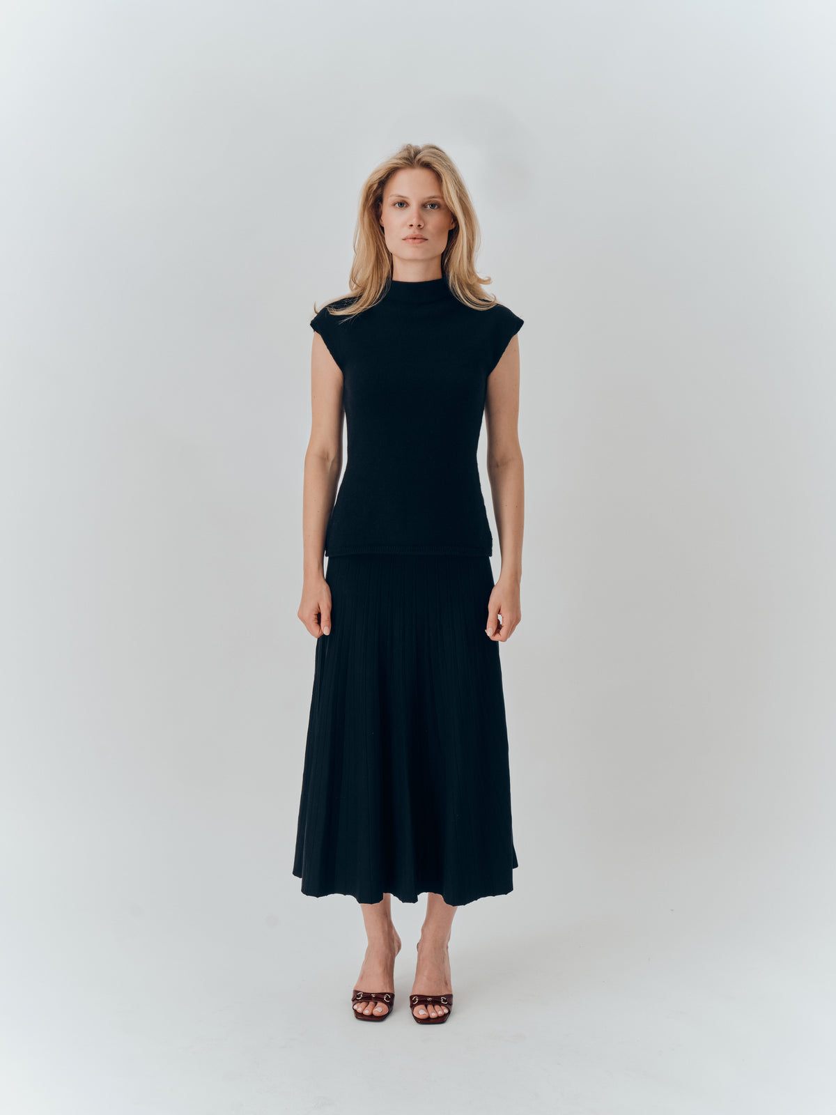 Thalia Top in Black cashmere, full-length view worn with a pleated midi skirt