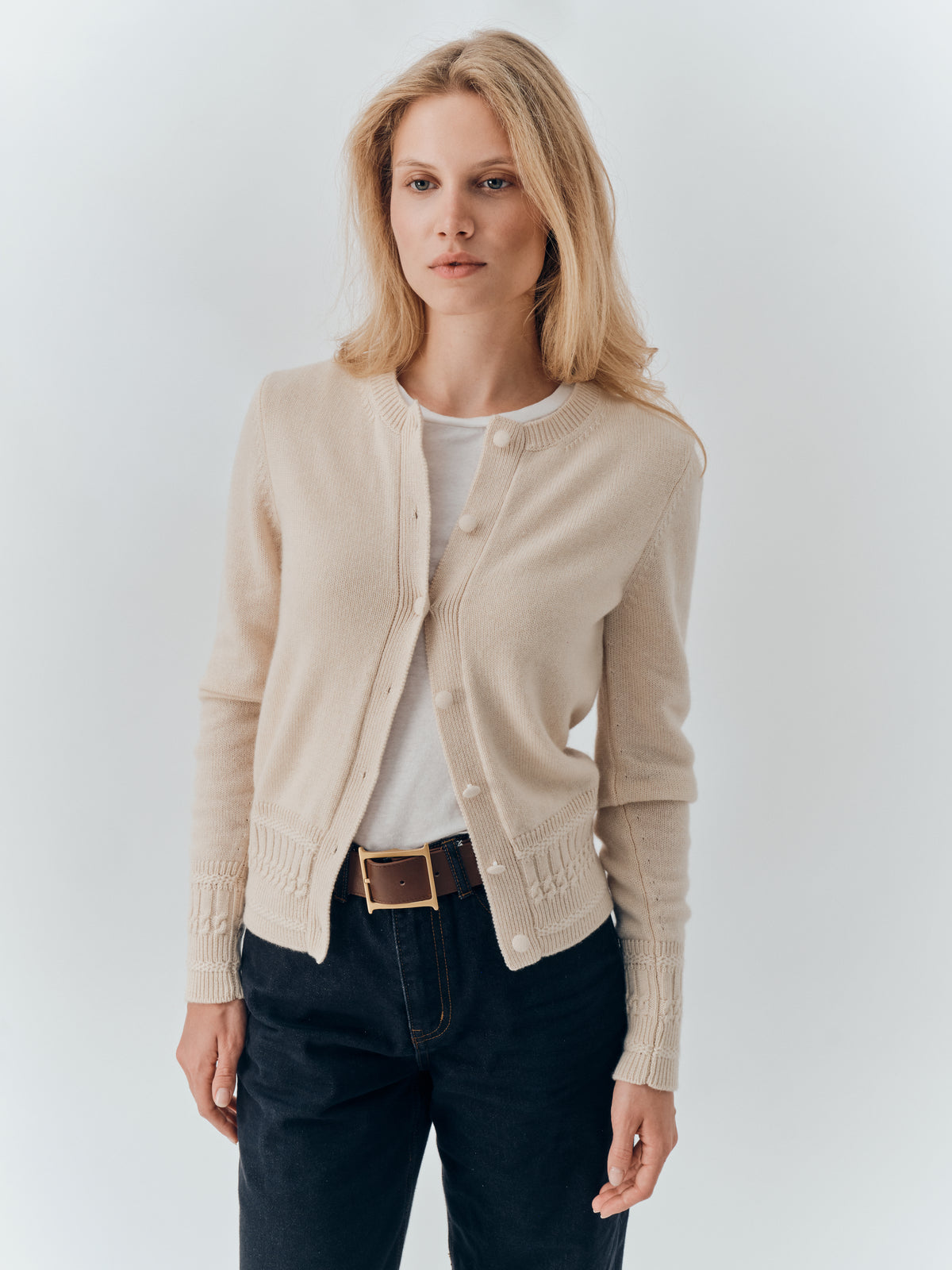 Emma Cardigan in Champagne cashmere, buttoned over a white tee with dark jeans