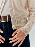 Emma Cardigan in Champagne cashmere, close-up of the covered buttons and textured hem