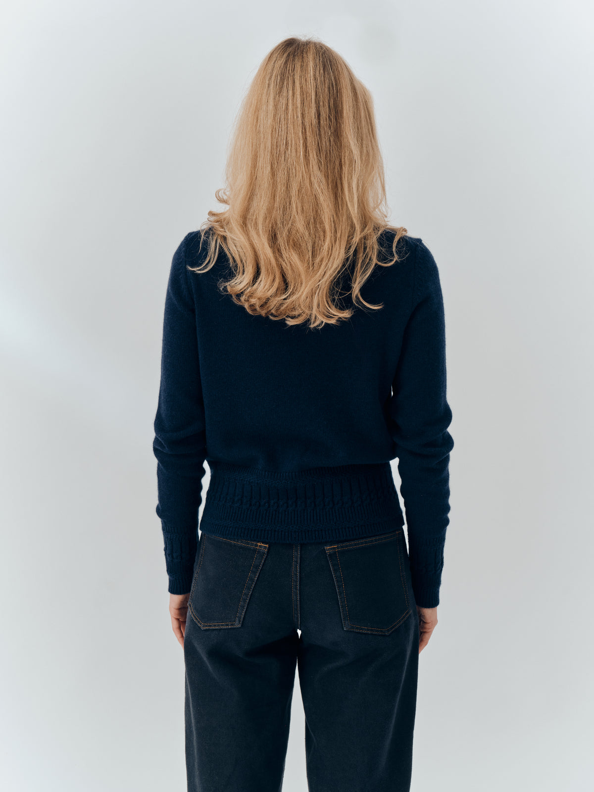 Emma Cardigan in Navy cashmere, back view worn with dark jeans