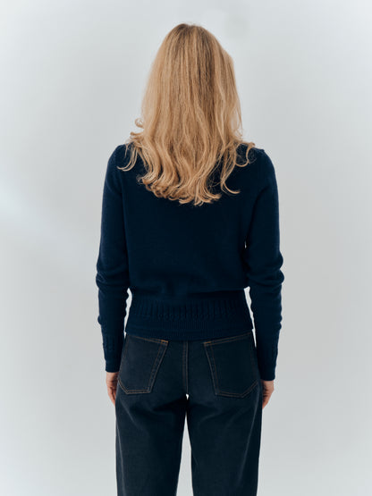 Emma Cardigan in Navy cashmere, back view worn with dark jeans
