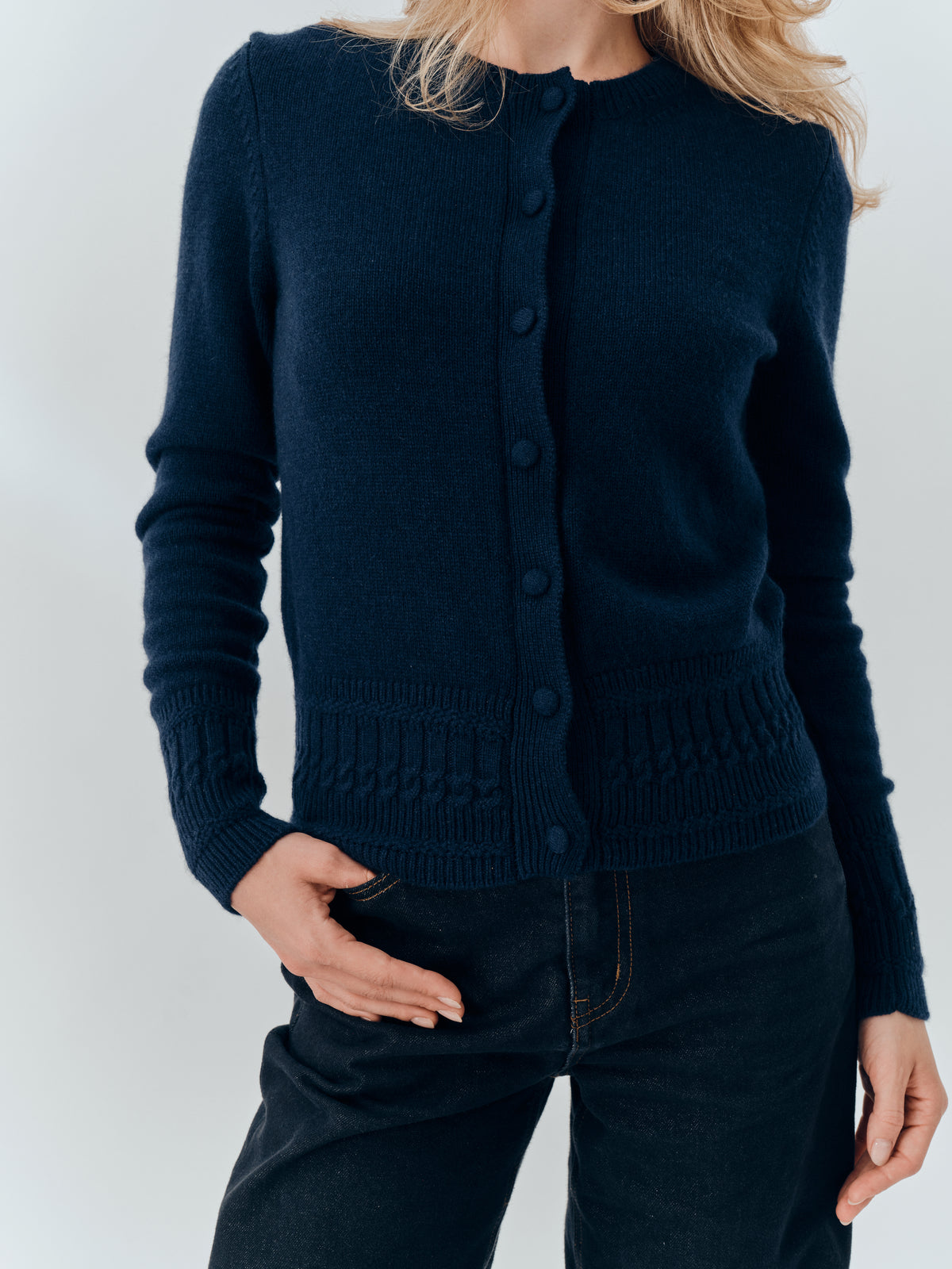 Emma Cardigan in Navy cashmere, buttoned, showing the placket and textured hem