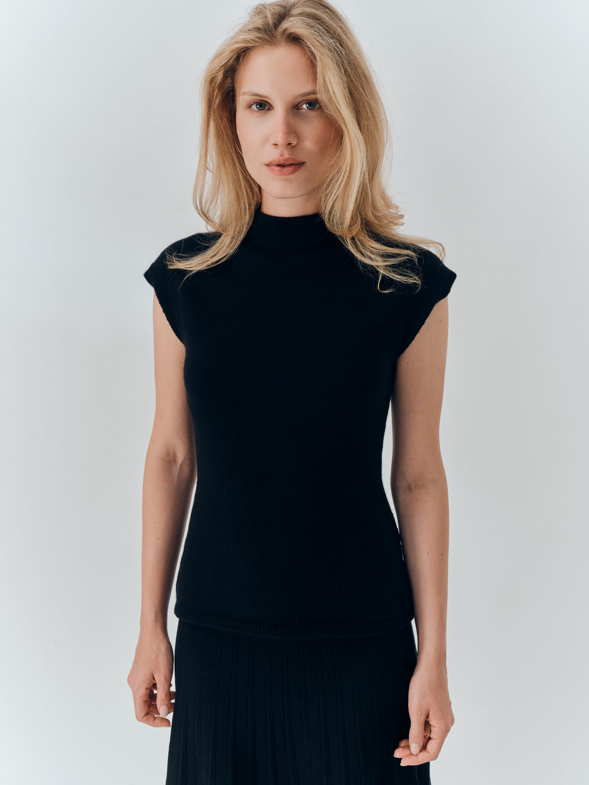 Thalia Top in Black cashmere, worn with a pleated midi skirt