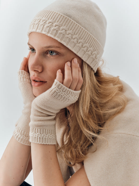 Cashmere wrist warmers in Champagne worn with the Cable Knit Beanie in Champagne